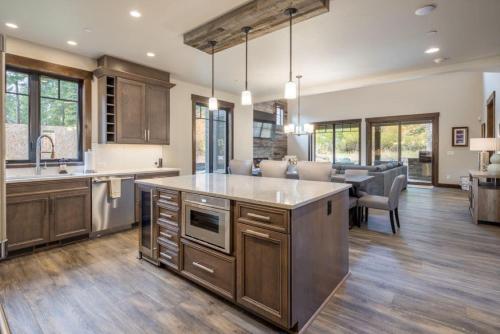 a kitchen with wooden cabinets and a dining room at Suncadia 4 Bdrm Home Beautiful Floor to Ceiling Fireplace in Cle Elum