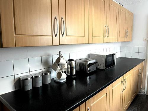 a kitchen counter with a coffee maker and a microwave at Crystal House- Liverpool City in Litherland