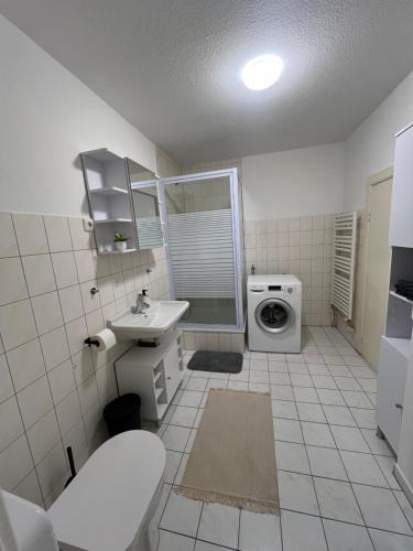 y baño con lavamanos y lavadora. en Schöne 2 Zimmer Wohnung in Lübeck en Lübeck