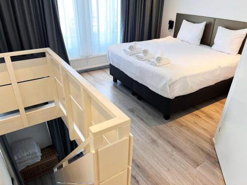 a small room with a bed and a staircase at Hotel de Duif Lisse - Keukenhof in Lisse