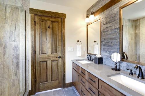 a bathroom with a sink and a wooden door at Great Location Near Pool with Suncadia Pool Access in Cle Elum