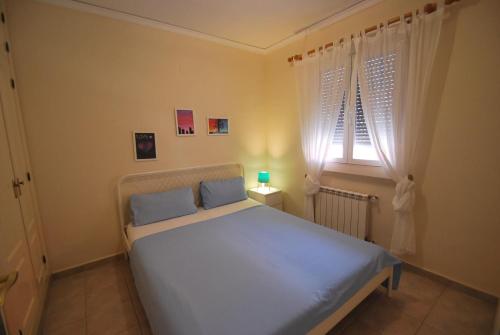 a bedroom with a white bed with a window at Holidayhome Melodia in Denia