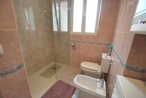 a bathroom with a toilet and a glass shower at Holidayhome Melodia in Denia