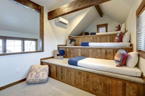 two beds in a room with wooden walls at Great Location Near Pool with Suncadia Pool Access in Cle Elum