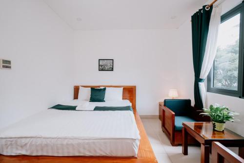 1 dormitorio con 1 cama, 1 silla y 1 ventana en Twins Hotel, en Ho Chi Minh