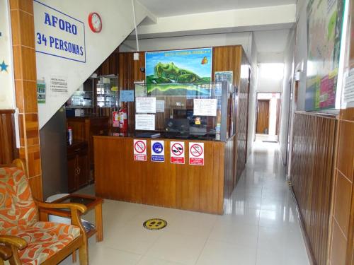 a restaurant with a counter with signs on it at Hostal Ucayali in Tingo María
