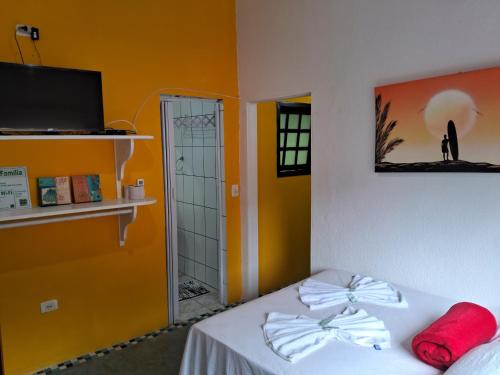 a room with a bed with red pillows on it at Pousada Familia Viva Trindade in Trindade