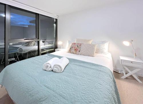 a bedroom with a bed with two towels on it at Pride Moonee Ponds 1B2B Nest in Melbourne