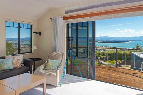 a living room with a view of the ocean at Jacaranda - Views over Tasman Bay in Nelson