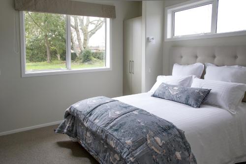 a bedroom with a large bed with a window at Grosvenor House B&B in Cambridge
