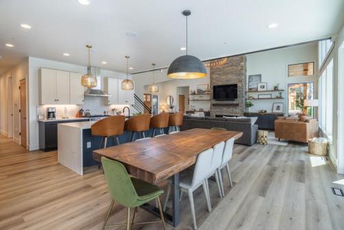 a kitchen and living room with a wooden table and chairs at Suncadia 5 Bdrm Home Nestled in the Forest Perfect Private Retreat in Cle Elum