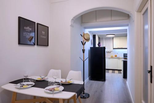 a dining room with a table and chairs and a kitchen at Acropolis 2BD Private Entrance Apt in Athens