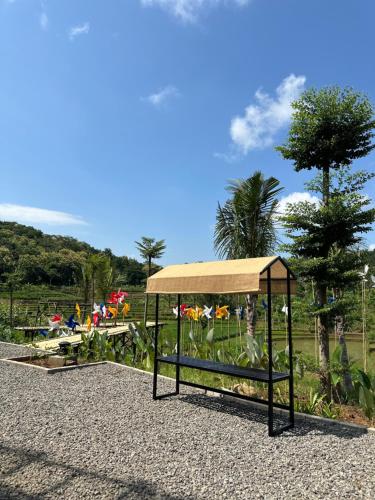 a park with a playground with tables and trees at Svarna Padi in Grigak