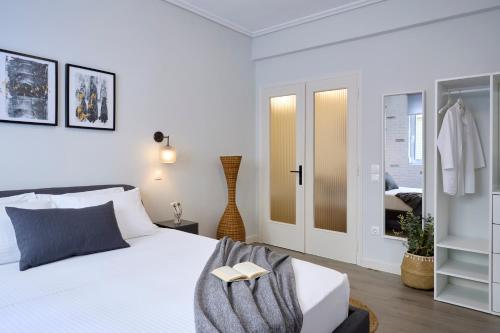 a bedroom with a bed with a book on it at Acropolis 2BD Private Entrance Apt in Athens