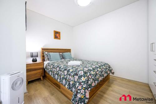 a small bedroom with a bed and a dresser and a bed sqor at MetaWise Burwood Westfield Cozy 2Bed Free Parking VT109 in Sydney