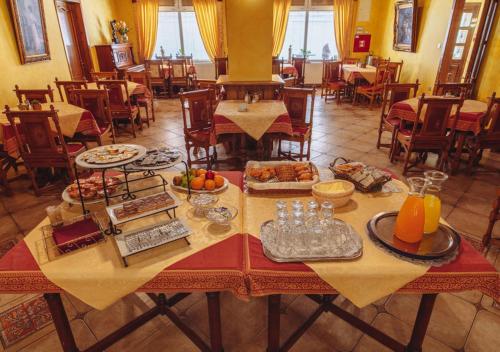 a table with food on it in a restaurant at Hotel Grande in Celje