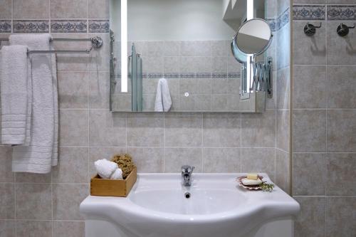 a bathroom with a sink and a mirror at Acropolis 2BD Private Entrance Apt in Athens