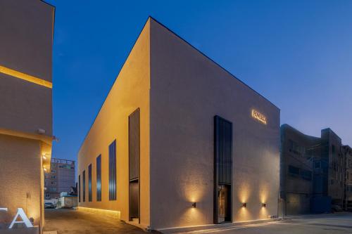 a large building with a lit up facade at Gyeongju Poverta Hotel in Gyeongju