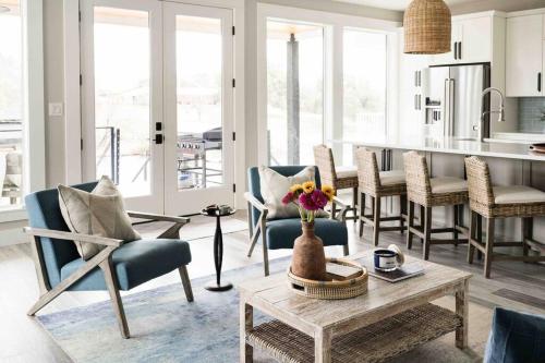 ein Wohnzimmer mit Stühlen und einem Tisch sowie eine Küche in der Unterkunft Luxury Lake LBJ Waterfront Home with Hot Tub and Boat Slip in Kingsland