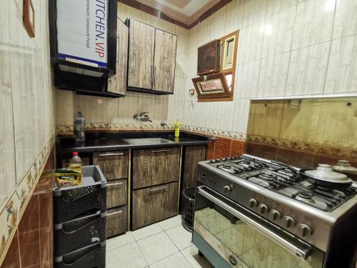 a kitchen with a stove and a sink in it at شقة فندقية في بورسعيد Hotel apartment in Port Said in Port Said
