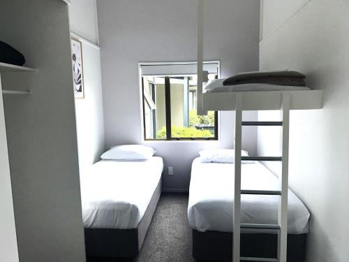 a small room with two beds and a window at Hastings TOP 10 Holiday Park in Hastings