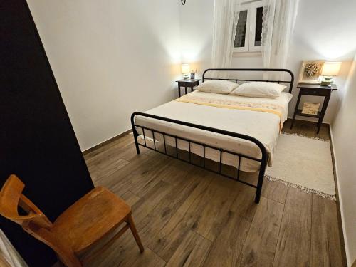 a bedroom with a bed and a chair at Apartments by the sea Rogoznica - 22448 in Rogoznica