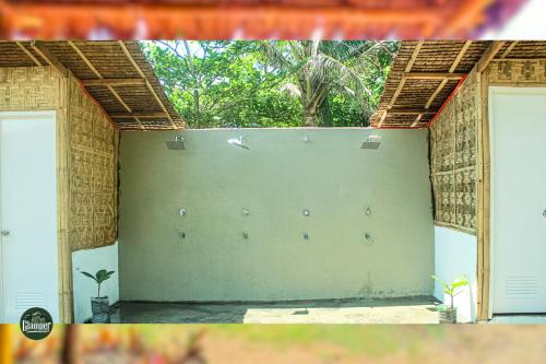 a garage with two doors and a wall at Glamper Grove- Real, Quezon in Tignuan