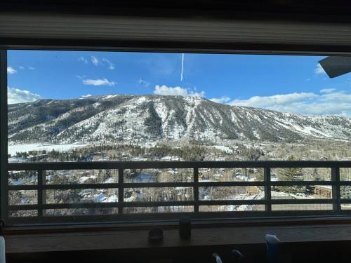 a view of a snow covered mountain through a window at Mountain Summit Serenity Aspen Views Adventure in Aspen