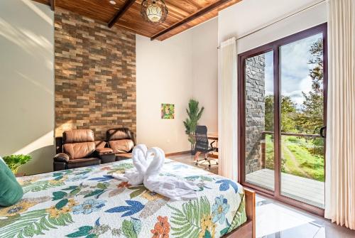 a bedroom with a bed and a living room at Cougar Monteverde in Monteverde Costa Rica