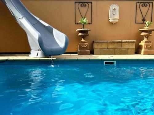 a slide in a pool with a swimming pool at Beachside SandDunes Villa Waterslide Gas Heat Pool in Tootgarook