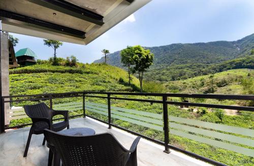 a balcony with chairs and a view of a mountain at Tara Waterfall in Rakwana