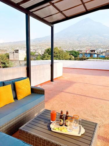 a table with drinks and a tray of food on a roof at Casa Balam Bed & Breakfast Boutique in Ciudad Vieja