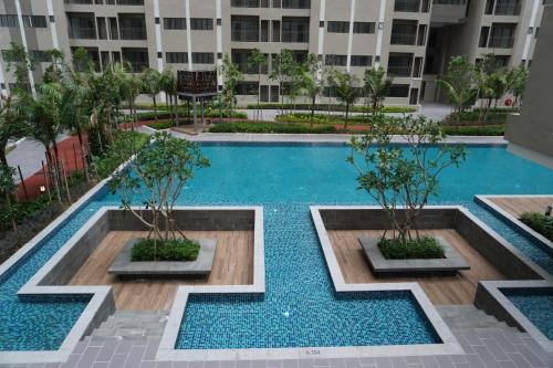 a swimming pool in the middle of a building at Camelia youth city nilai studio residence 5 pax. in Nilai
