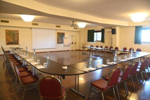 a large conference room with a long table and chairs at Renaissance Tuscany Il Ciocco Resort & Spa in Barga