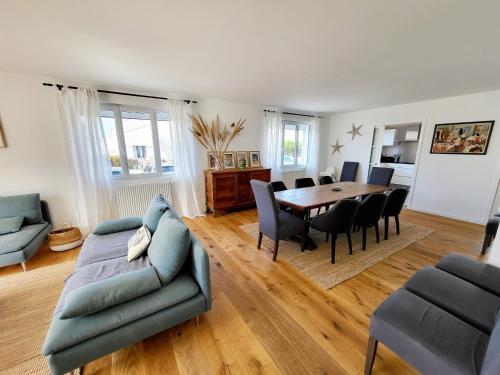 un salon avec un canapé, une table et des chaises dans l'établissement Maison Rénovée 5 Chambres, WiFi, Parking, à 800m du Marché et 1km Plage - FR-1-92-891, à Les Sables-dʼOlonne
