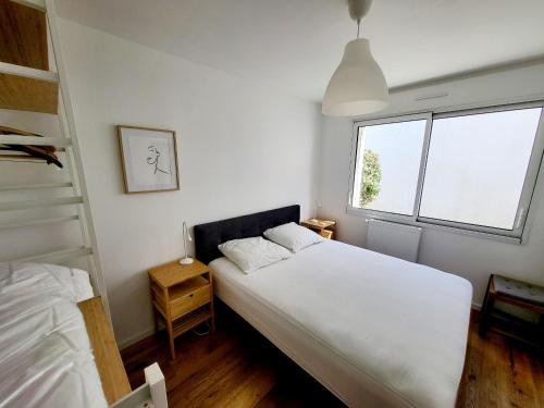 - une chambre avec un lit blanc et une échelle dans l'établissement Maison Rénovée 5 Chambres, WiFi, Parking, à 800m du Marché et 1km Plage - FR-1-92-891, à Les Sables-dʼOlonne