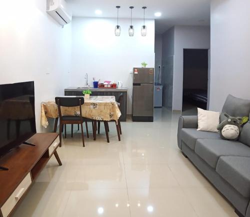 a living room with a couch and a table at Pantai Remis Homestay 118A in Pantai Remis