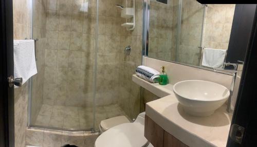 a bathroom with a shower and a toilet and a sink at Punta Centinella Yacht Club in Santa Elena