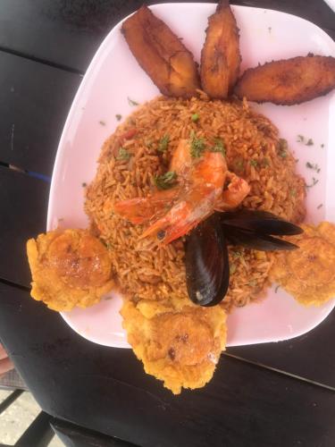 a plate of food with shrimp and rice and potatoes at Punta Centinella Yacht Club in Santa Elena