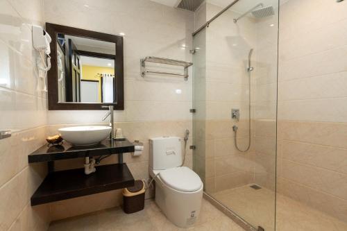 a bathroom with a toilet and a sink and a shower at Ohana Hoian Villa in Hoi An