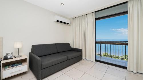 a living room with a couch and a large window at Studio 811 - Picturesque Beachfront Views in North Ward