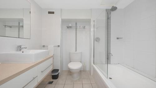 a bathroom with a toilet and a sink and a shower at Studio 811 - Picturesque Beachfront Views in North Ward