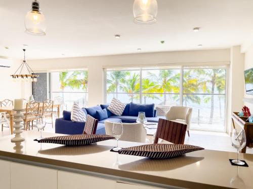 a kitchen and living room with a table and chairs at Olas del Mar by Playa Caracol Residences in Punta Chame