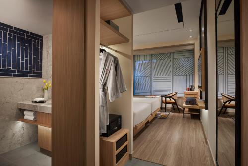 a bedroom with a bed and a desk in a room at Hyatt Centric Ballygunge Kolkata in Kolkata