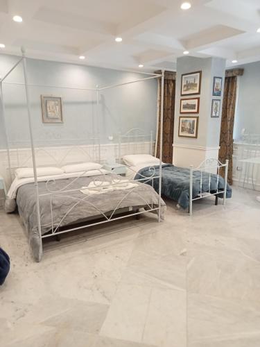 a bedroom with two beds in a room at Federico 70 Acquamarina in Palermo