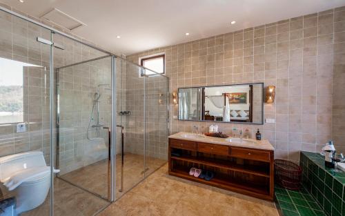 a bathroom with a shower and a sink at Relaxful Hotel泊岸酒店 in Luang Prabang