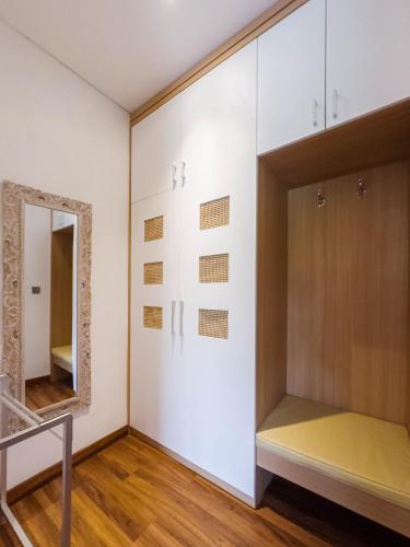 a dressing room with a mirror and a closet at Ubud Shanti Rice Field House By Supala in Ubud