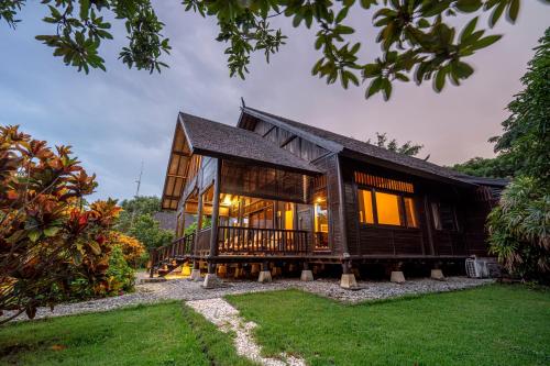 a house with a gambrel roof at Samawa Seaside Resort in Sumbawa Besar