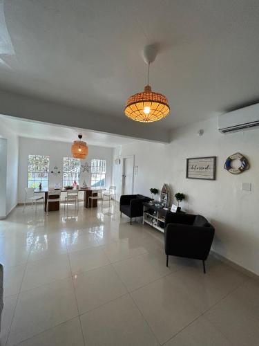 a living room with couches and a table and chairs at The Pelican Poshtel in San Juan
