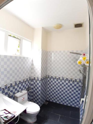 a bathroom with blue and white checkered tiles at Sweethome Resort & Spa Phú Quốc in Phú Quốc